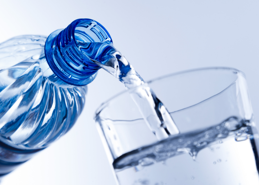 Bottle pouring water into a glass