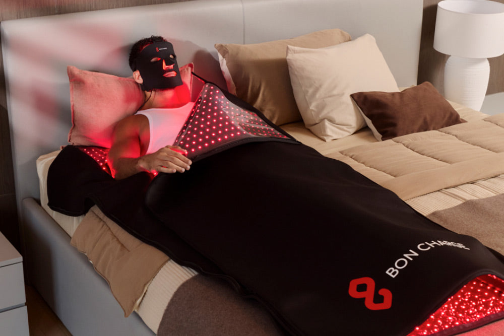 Man Wearing Red Light Face Mask Inside Red Light Therapy Blanket